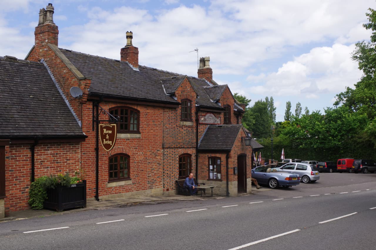 The red-brick exterior of The Horse and Jockey on Church Lane, Selston